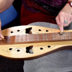 hands playing a dulcimer